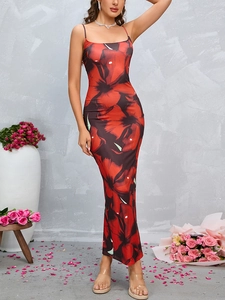 Detail of vintage floral maxi dress with red roses and elegant side slit hem