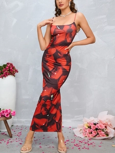 Detail of red floral slit dress showing spaghetti straps and black flower patterns