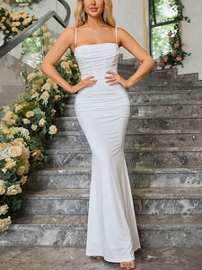 Detail of white ruching on a slim-fit fishtail dress with delicate spaghetti straps