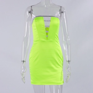 Detail of neon green bodycon mini dress featuring silver glitter V-neck trim