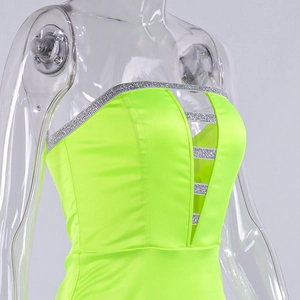 Detail of neon green strapless mesh dress with silver sequin straps and hollow-out front