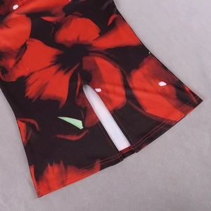 Detailed macro view of the floral print pattern and split hem stitching on this dress