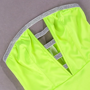 Detail of neon green satin strapless dress with sparkling silver rhinestone trim and V-neckline