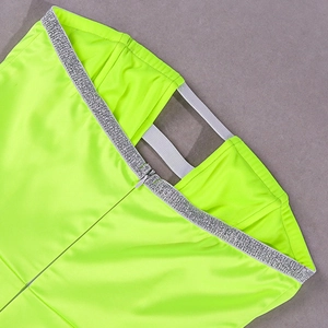 Detailed view of neon green satin dress featuring a concealed zipper and silver sequin trim