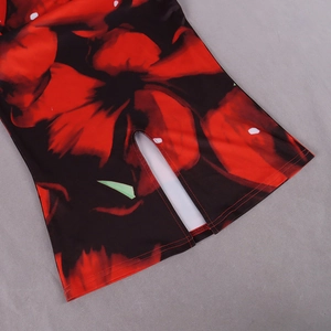 Close-up of red floral print on black dress featuring a stylish high side slit detail