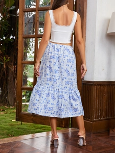 Detail of bohemian blue floral midi skirt with ruffle hem and white lace tank top back view