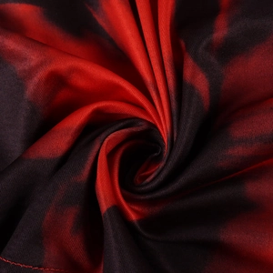 Detailed close-up of red and black tie-dye fabric with high-stretch knitted texture