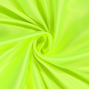 Detailed close-up of vibrant neon green silky fabric with elegant pleated spiral texture