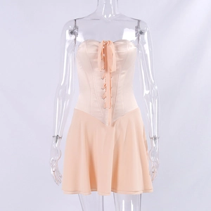 Detail of champagne satin corset bodice with lace-up boning and pleated skirt