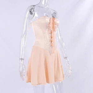 Detail of apricot satin corset dress with lace-up front and flowy A-line chiffon skirt
