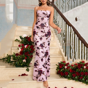 Pink satin slip dress with rose print and mermaid hem against marble stairs