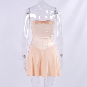 Detail view of the corset back design on a peach satin mini dress with structural boning