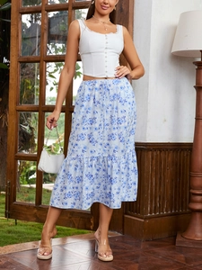 Detail of white button-down lace top paired with floral print midi skirt and ruffle hem