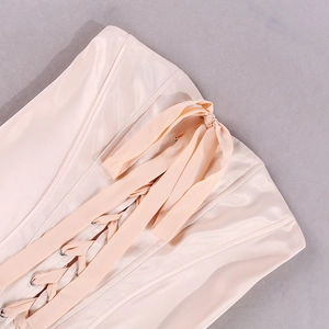 Detail of champagne satin corset dress showing back criss-cross ribbon and metal eyelets