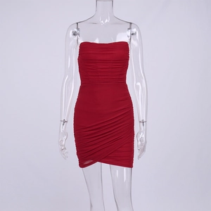 Detail view of red ruched mesh mini dress showing the cross wrap asymmetrical hemline