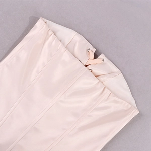 Detail view of the pink satin corset with metallic eyelets and crisscross lacing detail