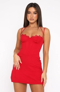 Detail of red corset dress featuring delicate lace trim and fishbone bodice structure