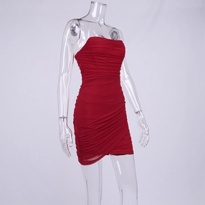 Detail of red mesh bodycon dress featuring horizontal ruching and asymmetric hemline