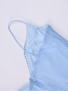 Détail de la robe en tulle bleu clair avec paillettes et bordure en strass au décolleté