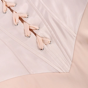 Close-up of pink satin dress featuring lace-up corset detail and silver eyelets