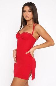 Detail view of red lace slip dress featuring eyelash lace trim and corset boning structure