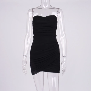 Detail of black ruched strapless mini dress with asymmetric crossover hem on a clear mannequin