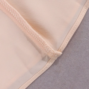 Detail showing high-quality stitching and seam binding on light chiffon fabric