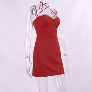 Detail of dark red corset dress showing lace trim, boning structure, and slim fit design