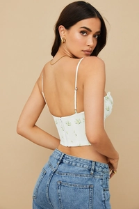 Rear view detail of floral corset top with thin straps and hidden back zipper closure