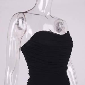 Detailed close-up of the black ruched mesh fabric texture on the bodycon dress