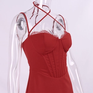 Close-up of red lace trim and boning structure on a backless corset dress detail