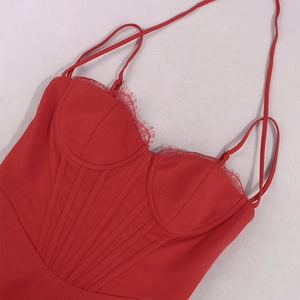 Detail of red lace trim and corset-style boning on a slim strap mini dress