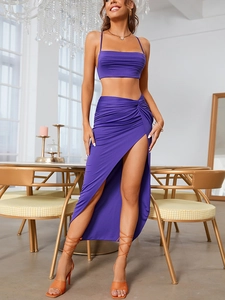 Detail view of purple two-piece set featuring a cropped top and ruched high-slit maxi skirt