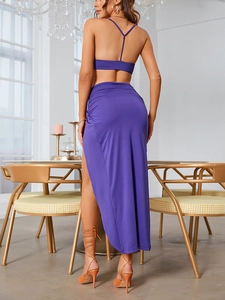 Detailed back view of purple two-piece set featuring Y-shaped straps and high slit skirt
