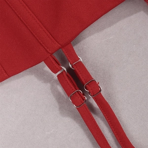 Detail of red lace dress showing adjustable silver buckles and fine stitching texture