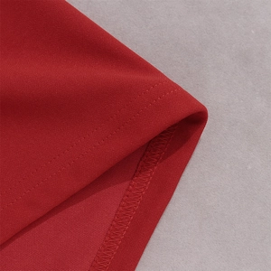 Detailed close-up of red lace dress showing high-quality stitching and seam finish