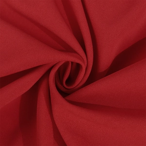 Macro detail of deep red lace fabric with elegant pleated texture and soft matte finish