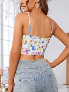 Detail view of floral crop top back with zipper closure and high-waist denim jeans