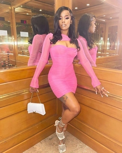 Detail of ruched rose pink mesh dress featuring a halter cutout and long sleeves