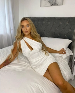 Detail of white one-shoulder ruched mini dress with elegant mesh and bodycon silhouette