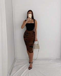 Detail of a square neck crop top paired with a ruched tiger print bodycon midi skirt