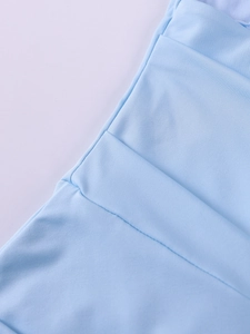 Close-up of the fine knit texture and high-quality edge stitching of the blue fishtail dress
