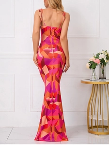 Detail of cross-back tie design and geometric print on a slim fit fishtail maxi dress