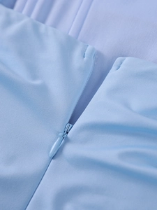 Close-up of seamless light blue invisible zipper on a backless fishtail dress