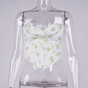 Detail view of floral corset top with ruched neckline and pointed hem on transparent mannequin