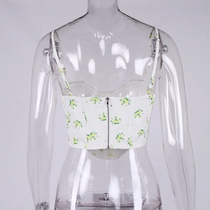 Detailed back view of white floral crop top featuring adjustable straps and zipper closure