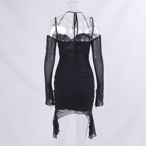 Detail view of the pleated texture and sheer mesh sleeves on this slim black dress