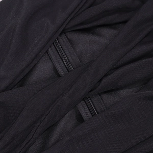 Detailed close-up of mesh fabric texture and dual zipper design on black ruched dress
