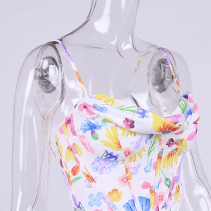 Detailed view of floral corset top with spaghetti straps and draped neckline on a model