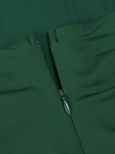 Detail view of high-quality invisible zipper closure on dark green knit evening dress